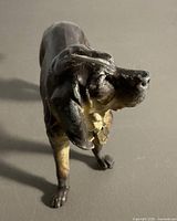 Front angled view of cast metal dog figurine