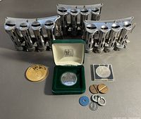 Group shot of three coin changers, medals, coins and tokens