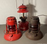 Front view of all three lanterns showing relative sizes, colors and globes