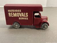 Left side view of maroon Matchbox Removals Service van
