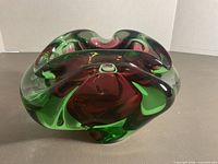 Front view showing green exterior and cranberry interior, free-form shape