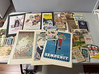 Overview of all posters and ephemera spread on table