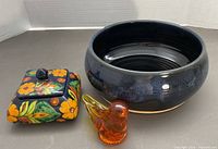Overall view of Talavera trinket box, blue pottery bowl, amber glass bird