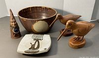 Group shot of wizard, two wood birds, bowl, plate