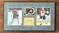 Full view of framed collage showing both signed photos, Flyers logo, and engraved plate