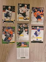 Seven hockey cards laid out on table