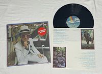 Front cover of Elton John Greatest Hits LP with shrink wrap and sticker