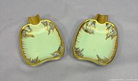 Pair of pale green square ashtrays with gold trim front view