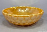 Oblique view of peach lustre Bubble bowl showing exterior pattern and colour