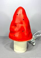 Front view of red mushroom lamp with cord visible