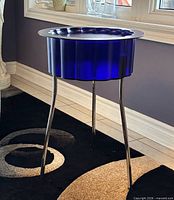 Full view of cobalt blue Hatten side table showing chrome legs