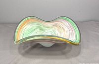 Top view showing wavy rim and pastel swirl interior