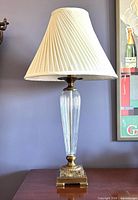 Full view of lamp with shade on cabinet