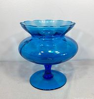 Front view of cobalt blue Empoli pedestal compote showing scalloped rim and bulbous body
