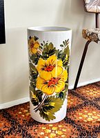 Front view showing full floral design on cylindrical stand