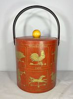 Front view of George’s Briard weather vane ice bucket showing graphics and handle