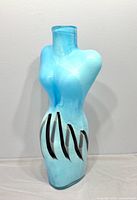 Front view of blue female torso art glass vase