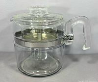 Side view assembled percolator showing handle, lid, metal collar