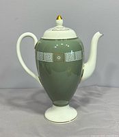 Full left side view showing overall form, handle, spout, lid and pattern