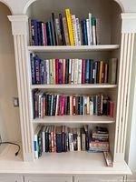 Front view of four shelves filled with assorted books