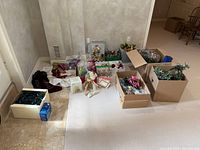 Overview of all Christmas decorations spread on floor including boxes and loose items