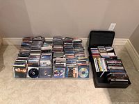 Wide view of entire lot showing tubs of CDs and stack of DVDs