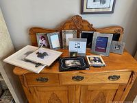 Entire grouping of assorted frames on dresser