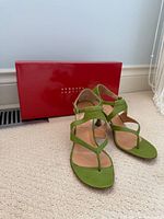 Pair of green leather sandals in front of red Edmundo Castillo box