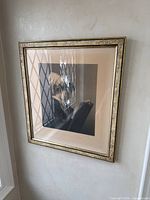 Framed art print on wall, full view showing image, mat, and frame