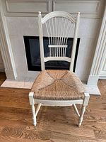 Front view of painted wood chair showing spindle back and rush seat