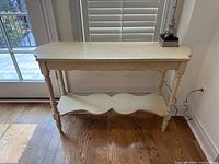 Oblique view of entire console table showing legs, shelf, and surrounding context