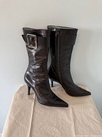 Both boots side view showing leather, buckle, heel height