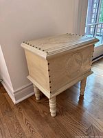 Front and side view of painted carved wooden chest on turned legs