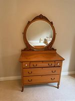 Full view of dresser with oval mirror front