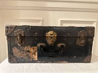 Front view showing latches, lock, handle, worn exterior