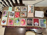 Top view of assorted floral, heart, thank you, Father and abstract 5 x 7 in greeting cards with envelopes on table
