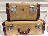 Two stacked Langmuir Miralite tweed hard-shell suitcases showing front latches and handles