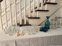 Full lot showing decanter, glasses, jars, figurines