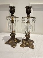 Full view of both brass candlesticks with prisms