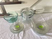 All items: Pyrex double boiler, Anchor bowl, stacks of saucers and dinner plates
