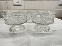 Five clear pressed glass compotes front view on cloth