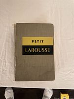Front cover showing title 'Petit Larousse' on grey cloth