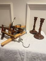 overall lot showing seven wooden clamp hangers and two wooden candlesticks