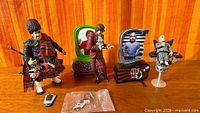 Group view of all three figures, display bases and accessory bag