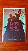 Front cover of Batman/Grendel: Devil's Riddle comic in bag