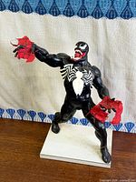 Full view of Venom statue on base