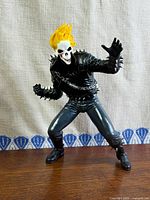 Front view of Ghost Rider figure standing on wood surface