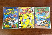 Front covers of all three Itchy & Scratchy Comics issues #1-3, bagged and boarded