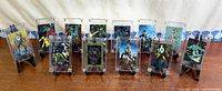 Full set of 13 chromium trading cards in holders lined up on easels