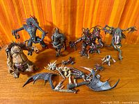Group of seven Spawn figures with loose wings, weapons and parts